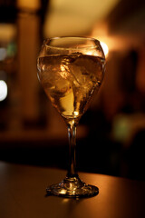 cocktail with backlight in golden tones in bar
