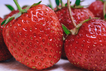 Fresh ripe strawberry on textured white table. Close-up. Macro.