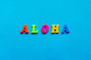 word aloha on blue paper background