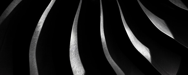 Metallic steel blade on the dark, Aircraft turbojet close up, Black and silver steel abstract texture, modern background with curves and shadow