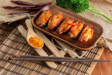 Spicy buffalo chicken wings covered by spices.