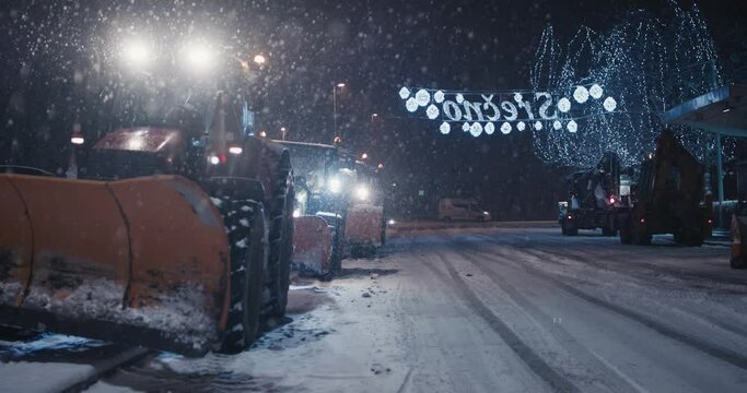 Tractor snow plow machines parked mid winter pandemic night curfew