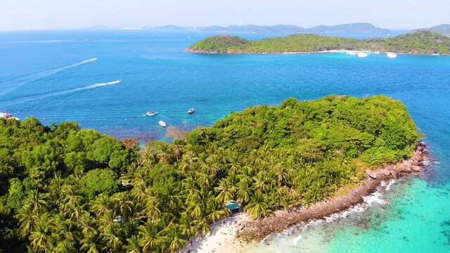 Aerial view of beautiful landscape, tourism boats, and people swimming on the sea and beach on May Rut island (a tranquil island with beautiful beach) in Phu Quoc, Kien Giang, Vietnam.