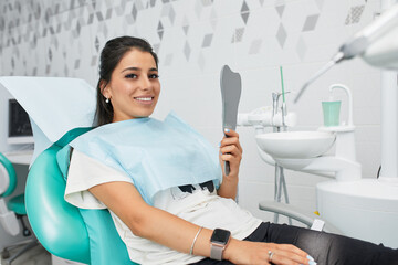 Overview of dental caries prevention.Woman at the dentist's chair during a dental procedure....