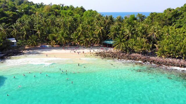 Aerial view of beautiful landscape, tourism boats, and people swimming on the sea and beach on May Rut island (a tranquil island with beautiful beach) in Phu Quoc, Kien Giang, Vietnam.