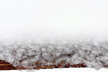 Winter frosty background with frosty patterns on a wooden surface. Very soft selective focus.