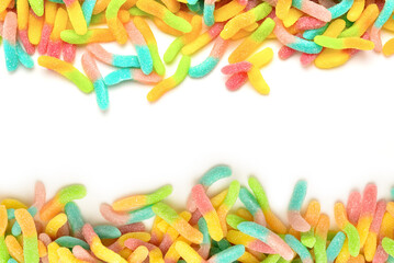 Frame of colorful gummy candies isolated on white. Top view. Space for text or design.