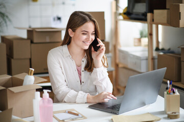 Young woman dropshipper with laptop working at home, coronavirus concept.