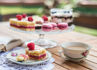 Cup of coffee and desserts on table, close-up.