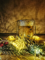 New year's and Christmas  composition: a Cup of cappuccino, a branch of spruce and garlands