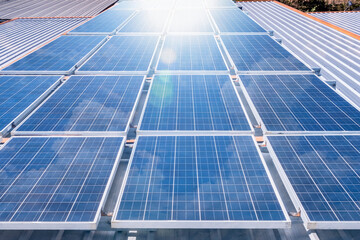 Solar panels on rooftop with sun reflect light power for alternative energy photovoltaic safe...