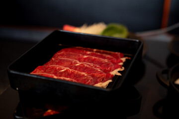 Slide raw beef served on black tray for Yakiniku.