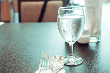 Cold water in glass on dinner table