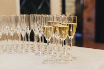 Galsses with white sparkling wine on the table.