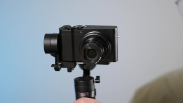 Using a gimbal to stabilize a video camera and reduce shake. Closeup of a camera mounted on the gimbal being used.
