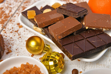 sweet food top view background for merry christmas or new year holiday decoration - chocolate candies, tangerines, cookies on white wood