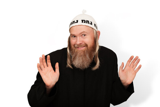 Smiling bearded Orthodox jewish man isolated on white background. Cheerful charismatic Jew with sidelocks in white yarmulke showing palms and hinting that he has nothing to do with it.