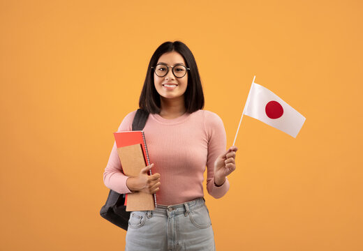 Language Study And Exchange Student. Smiling Young Asian Female Holding Japan Flag