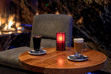 Mulled wine and latte on fireplace