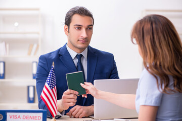Young woman visiting american embassy for visa - obrazy, fototapety, plakaty