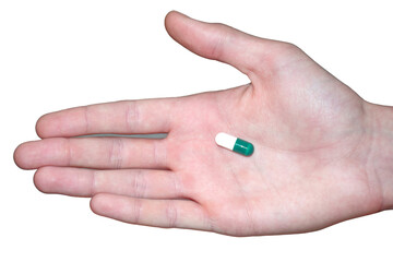 Tablet or capsule on the palm of the doctor, close-up photography on a white background. Medicine in hand for treatment