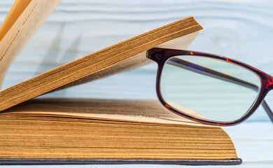 Reading glasses on an open book. Idea for reading books