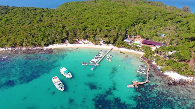 Aerial view of beautiful landscape, tourism boats, and people swimming on the sea and beach on May Rut island (a tranquil island with beautiful beach) in Phu Quoc, Kien Giang, Vietnam.