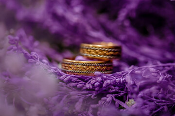 Gold rings on purple flowers. Dried flowers
