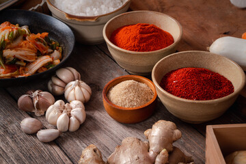 Fresh ingredients and vegetables Placed in the table For making Kimchi Which contains ingredients such as ginger, garlic, salt, onion, sugar, gochugaru (Korean chili). Kimchi is a healthy food.