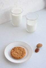 Energy balls. Homemade healthy raw energy balls with carob, figs decorated cocoa with glasses of milk on white background. Sugar free candies and  vegetarian truffles.