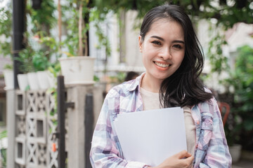 Fototapeta premium Portrait cheerful of young asian student in a cafe.