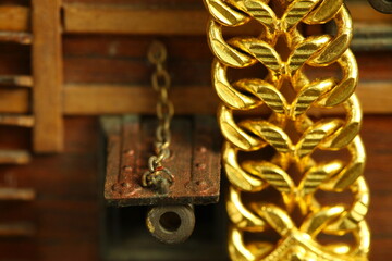 Gold necklace and miniature ship model scene represent treasure and transportation business concept related idea.