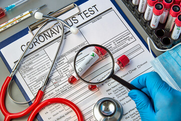 Test tubes with blood tests for COVID-19 on the test form for . Blood test for the presence of...