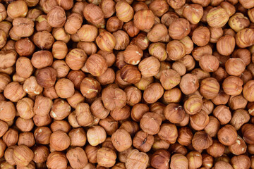 Fried hazelnuts laid out in a thick layer so that the bottom is not visible