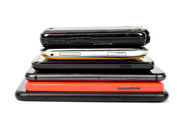 Smartphones stacked stack on top of each other and isolated on white background