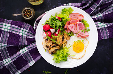English  breakfast - fried eggs, ham, fried mushrooms, radish and arugula. ketogenic, keto  food. Top view, overhead, copy spac