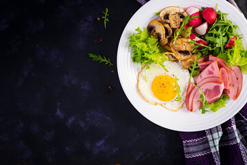 English  breakfast - fried eggs, ham, fried mushrooms, radish and arugula. ketogenic, keto  food. Top view, overhead, copy spac
