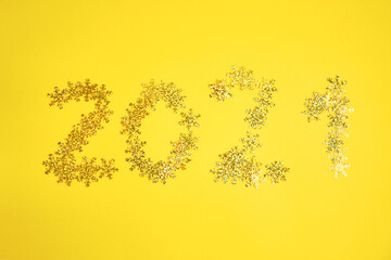 New 2021 year backgound. Golden snowflakes on yellow background