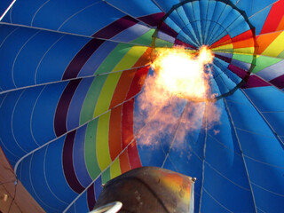 On-board view of a hot air balloon's burner engine propelling it into the sky with a burst of hot air.