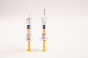 Two syringes on white background for injection. Healthcare and Medical concept for covid-19. A covid-19 coronavirus vaccination concept. It use for prevention, immunization and treatment.