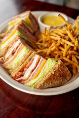 Club sandwich. BLT chicken sandwich. Classic sandwich made with ham, turkey, bacon, cheese, onions, lettuce, tomato, mayo,  salt and pepper. Classic diner or barbecue restaurant favorite.