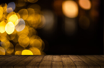 blurred background of xmas tree lights and wall with table of brown color