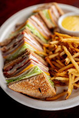 Club sandwich. BLT chicken sandwich. Classic sandwich made with ham, turkey, bacon, cheese, onions, lettuce, tomato, mayo,  salt and pepper. Classic diner or barbecue restaurant favorite.