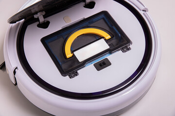 Robot vacuum cleaner with open lid and installed garbage container, top view.
