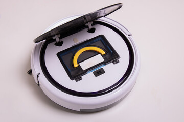 Robot vacuum cleaner with open lid and installed garbage container, top view.