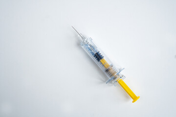Syringe on white background for injection. Healthcare and Medical concept for covid-19. Covid-19 coronavirus vaccination concept. It use for immunization and treatment. Flat lay, top view, copy space.