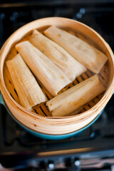 Tamales. Classic méso-américain or Mexican cuisine. Seasoned Meats wrapped in masa dough and steamed in corn husks or banana leaves. Traditional regional cuisine.