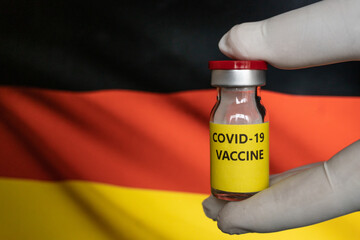 Bottle vaccine DEU. It use for prevention, immunization and treatment from corona virus infection (novel coronavirus disease 2019, Covid-19). Germany Flag background. Coronavirus vaccine in Germany. 