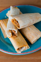 Tamales. Classic méso-américain or Mexican cuisine. Seasoned Meats wrapped in masa dough and steamed in corn husks or banana leaves. Traditional regional cuisine.