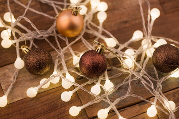 Christmas light bulbs on dark wooden background.